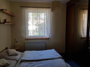 En eller flere senge i et værelse på Pobierowo Bracka