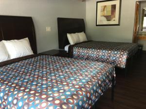 a hotel room with two beds in a room at Budget Inn - Laurens in Laurens