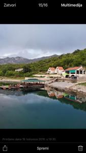 a picture of a body of water with a dock at Splav "Slap" - Bungalovi in Danilovgrad