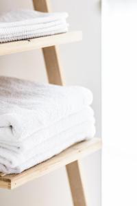 a stack of towels on a shelf at The Roof in Kfar Blum +26 photos