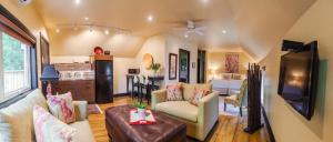 a living room with a couch and a tv at Avery House B&B in Stratford