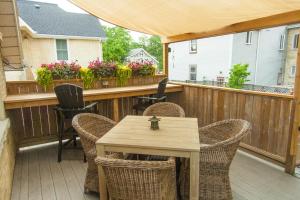 a patio with a table and chairs on a deck at Avery House B&B in Stratford