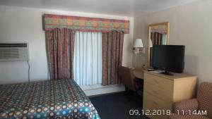 a hotel room with a bed and a television at Rivers EDGE MOTEL in Louisiana