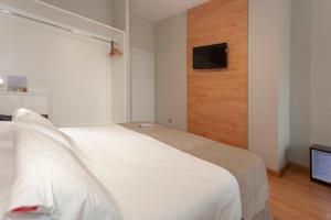 Postel nebo postele na pokoji v ubytování AACR Hotel Monteolivos