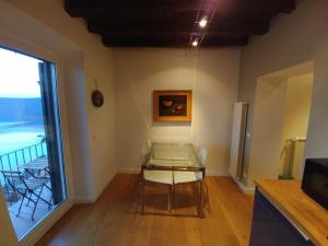 a dining room with a glass table and a window at Casa Albalonga in Castel Gandolfo