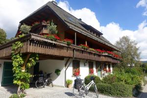a house with two bikes parked outside of it at Hollhouse - Bed & Breakfast in Hinterzarten