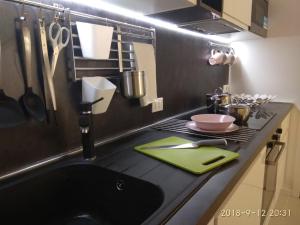 a kitchen with a black counter top with a sink at Milan center Luxury House in Sesto San Giovanni +29 photos