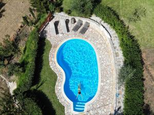 The swimming pool at or close to Vrisali Traditional Stone Villa