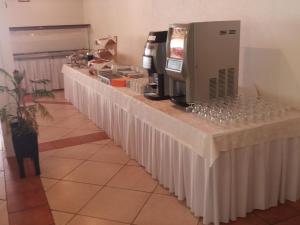 a long table with wine glasses and a coffee maker at Pansion Comfort Sidro in Novalja
