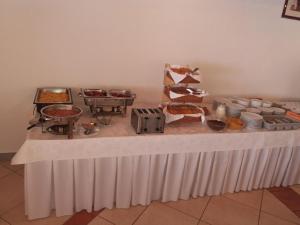 a table with a buffet of food on it at Pansion Comfort Sidro in Novalja