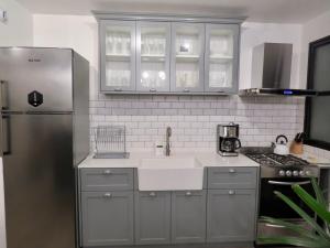 a kitchen with a sink and a refrigerator at Anita's Place in Buenos Aires