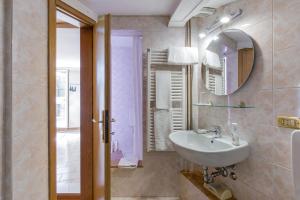 a bathroom with a sink and a mirror at Gheller Apartment in Verona