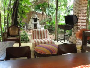 a living room with a chair and a microphone at Casa Real Del Cabrero by Soho in Cartagena de Indias