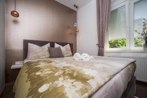 Posteľ alebo postele v izbe v ubytovaní Citylux Apartments