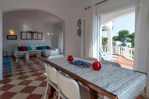 a dining room with a table and chairs and a couch at VILLA ALONDRA B6 in Santo Tomás