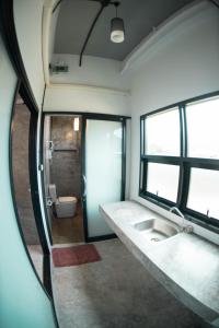 a bathroom with a large sink and a toilet at The Ele Hotel Ranong - SHA Extra Plus in Ranong