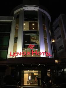 a building with a neon sign on the front of it at Lenox Hotel in Dagupan