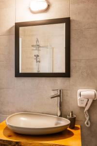 a bathroom with a sink and a mirror at Djumba Hotel & Cafe in North Nicosia