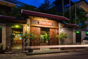 a building with a sign on the front of it at Pak Chiang Mai in Chiang Mai