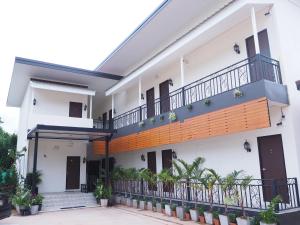 a house with a balcony with plants at Kangsadan Resort in Loei