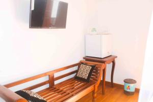 a wooden bench sitting in a room with a microwave at Dream Villa Galle Fort in Galle