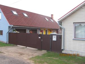 a house with a fence in front of it at Ziedu pasaule in Krāslava