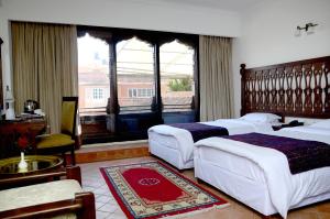 A bed or beds in a room at Hotel Manaslu