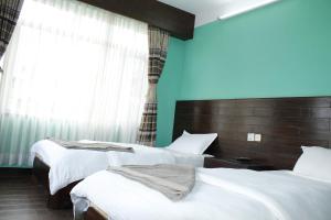 Ein Bett oder Betten in einem Zimmer der Unterkunft Mount Annapurna Guest House