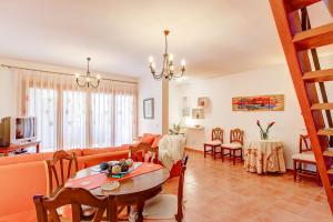 a living room with a couch and a table at Llac Gran in Port d'Alcudia
