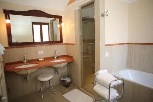 a bathroom with two sinks and a shower and a tub at Palazzo Iaquinto in Santa Maria di Castellabate +62 photos