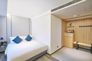 Ein Bett oder Betten in einem Zimmer der Unterkunft Hotel COZi Oasis