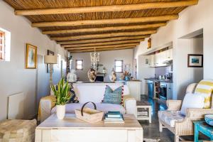a living room with a wooden ceiling at Sugar Shack in Paternoster