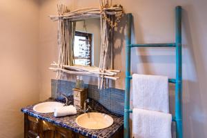 a bathroom with a sink and a mirror at Sugar Shack in Paternoster +40 photos