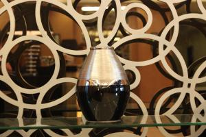 a vase sitting on top of a glass table at The Plaza Hotel Balanga City in Balanga