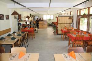 un ristorante con tavoli e sedie e persone sullo sfondo di ROKPA Guest House a Kathmandu