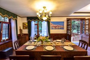 a dining room with a table and a chandelier at Nordic Memory in Qingdao in Qingdao +64 photos