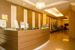 a lobby with a reception counter and a restaurant at Garden Hotel in Taichung