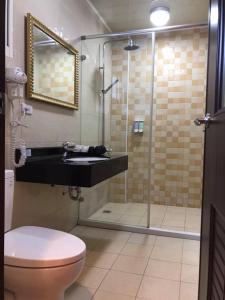 a bathroom with a shower and a sink and a toilet at Seasons Homestay in Xiaoliuqiu