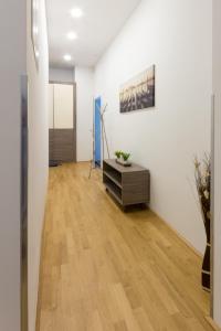 a room with white walls and a wooden floor at Debo Apartments nähe Westbahnhof - contactless check in in Vienna