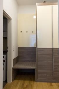 a walk in shower with a glass door in a room at Debo Apartments nähe Westbahnhof - contactless check in in Vienna