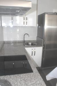 eine Küche mit einer Spüle und einem Kühlschrank aus Edelstahl in der Unterkunft Apartamento Gaviotas in Tarifa