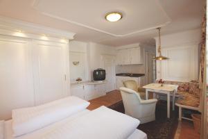 a living room with a bed and a table and chairs at Haus Hildegunde in Bad Füssing