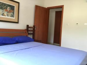 a bedroom with a bed with blue sheets and a mirror at Mystra Place in Nicosia