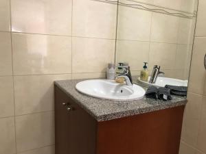 a bathroom with a sink and a mirror at Mystra Place in Nicosia