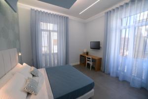 Televízia a/alebo spoločenská miestnosť v ubytovaní In Centro B&B