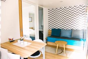 a living room with a blue couch and a table at Vännäs Camping in Vännäs