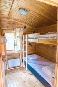 a bedroom with two bunk beds in a cabin at Vännäs bad & camping in Vännäs