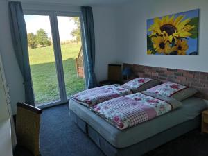a bedroom with a bed in front of a window at Sonnenhof in Charlottenthal