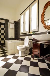 a bathroom with a toilet and a tub and a sink at Jonker Boutique Hotel in Melaka