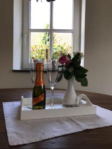 a bottle of wine and glasses on a table at Hotel Hoeve de Plei in Mechelen
